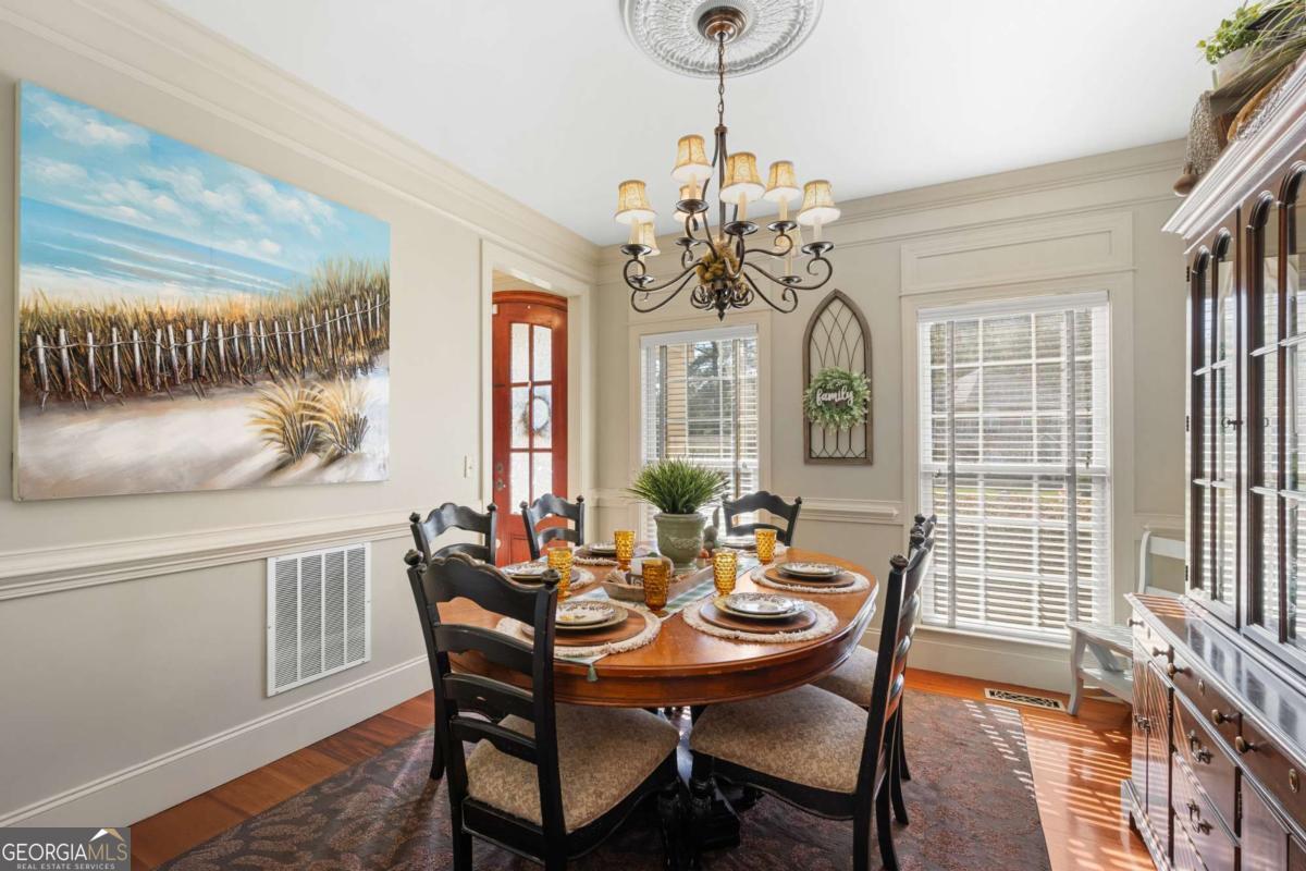 201 Walthour Drive Rincon, GA 31326 - Photo 12 of 29 a view of a dining room with furniture wooden floor and chandelier