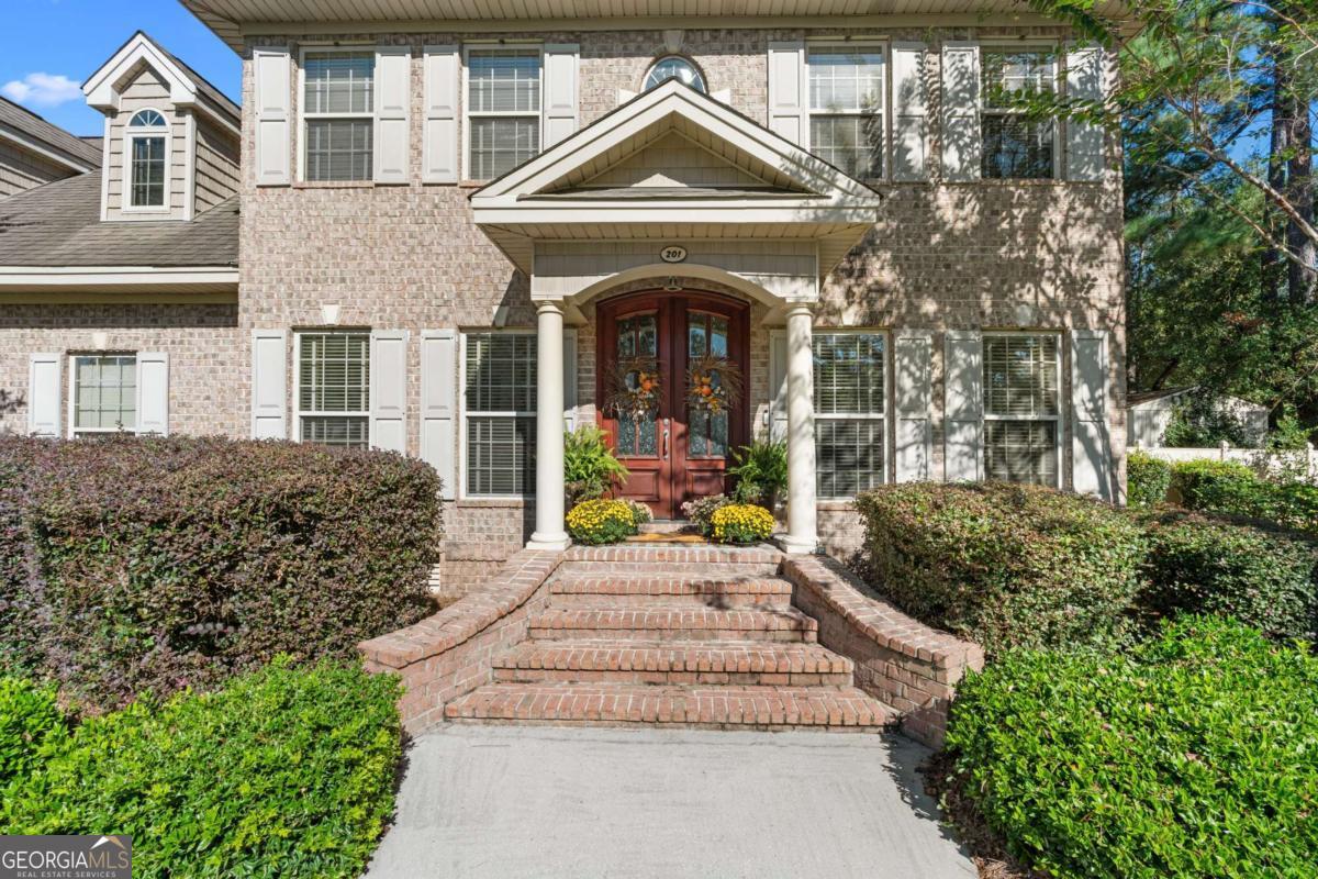 201 Walthour Drive Rincon, GA 31326 - Photo 3 of 29 a front view of a house with garden