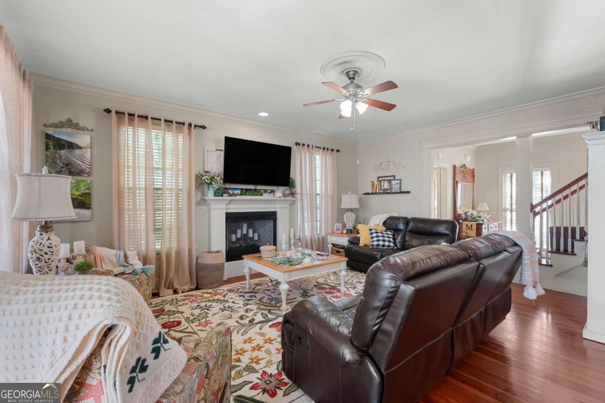 201 Walthour Drive Rincon, GA 31326 - Photo 7 of 29 a living room with furniture a fireplace and a flat screen tv