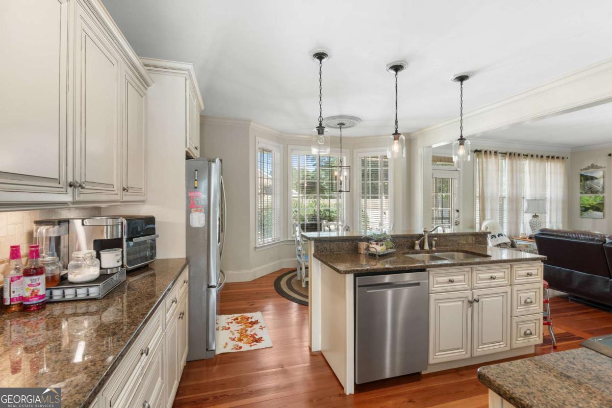 201 Walthour Drive Rincon, GA 31326 - Photo 10 of 29 a kitchen with stainless steel appliances granite countertop a stove and a wooden floors