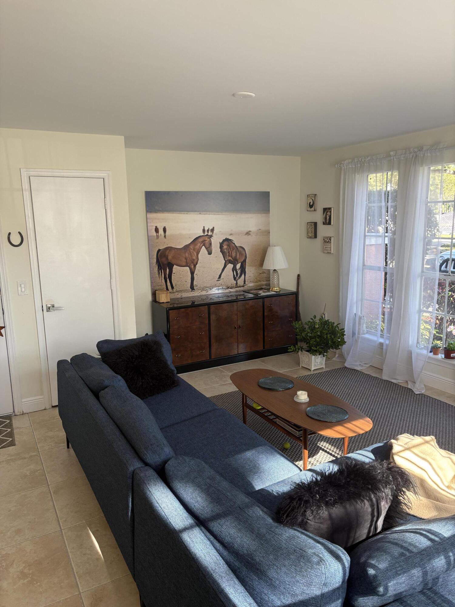 1001 Crystal Way, Unit A Delray Beach, FL 33444 - Photo 4 of 10 a living room with furniture and a window