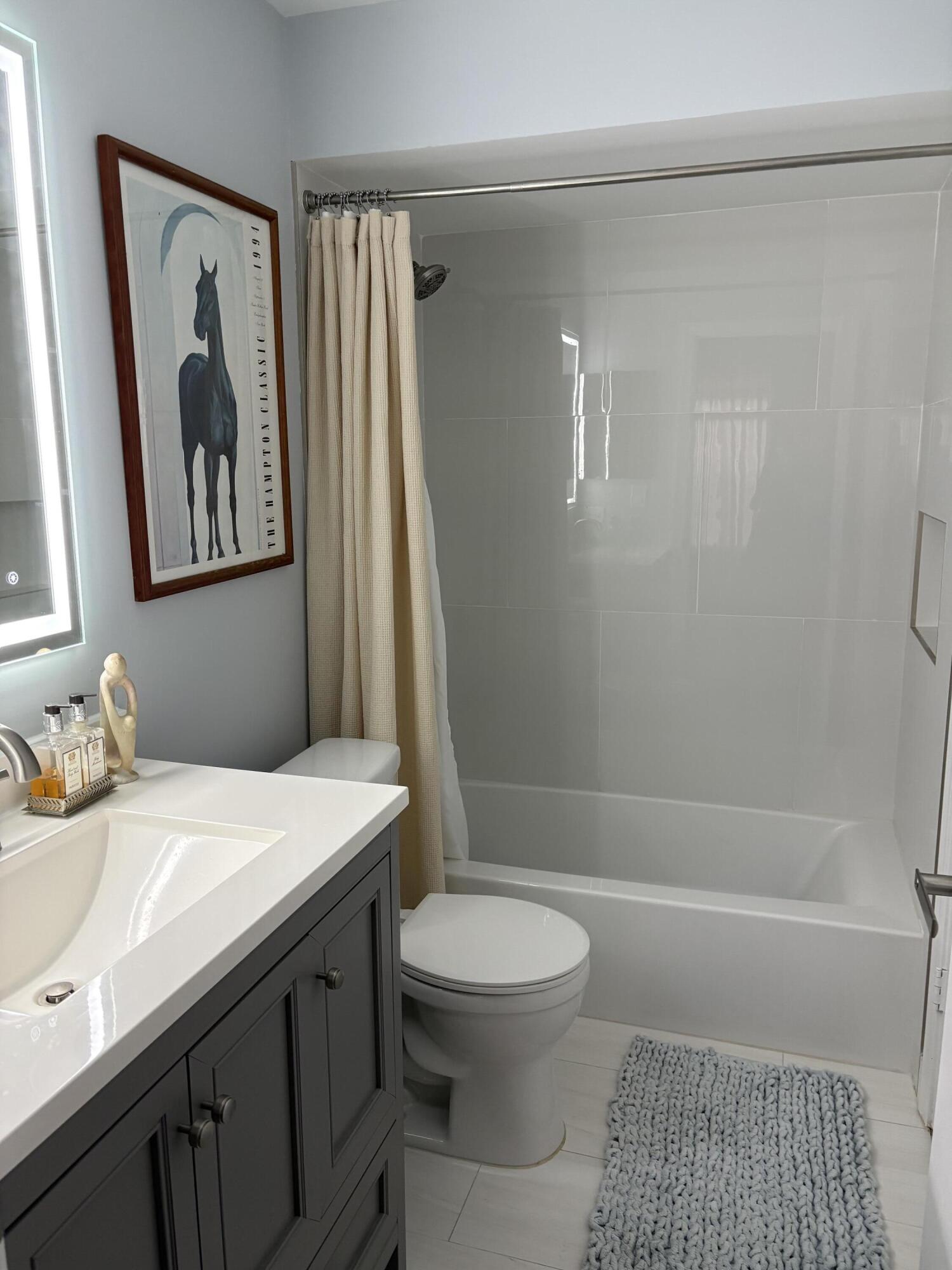 1001 Crystal Way, Unit A Delray Beach, FL 33444 - Photo 9 of 10 a bathroom with a sink a toilet and shower