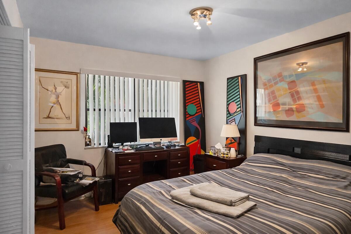 20952 Delagado Terrace Boca Raton, FL 33433 - Photo 11 of 27 a bedroom with a bed and a flat screen tv