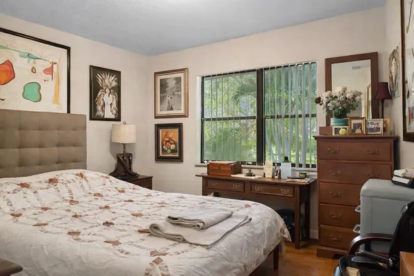 a bedroom with a bed and a large window