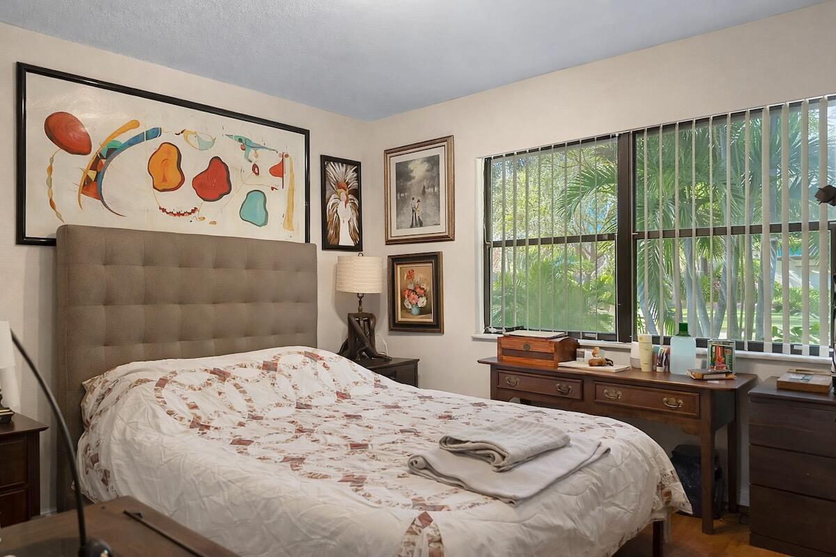 20952 Delagado Terrace Boca Raton, FL 33433 - Photo 22 of 27 a bedroom with a bed and a large window