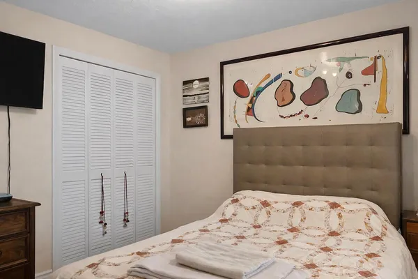 a bedroom with a bed and a dresser