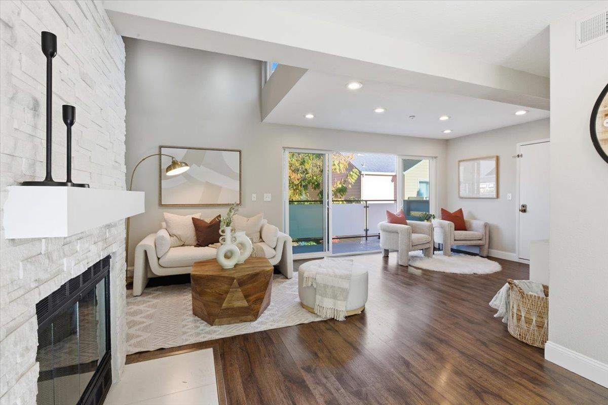 363 North Rengstorff Avenue, Unit 5 Mountain View, CA 94043 - Photo 16 of 35 a living room with fireplace furniture and a wooden floor