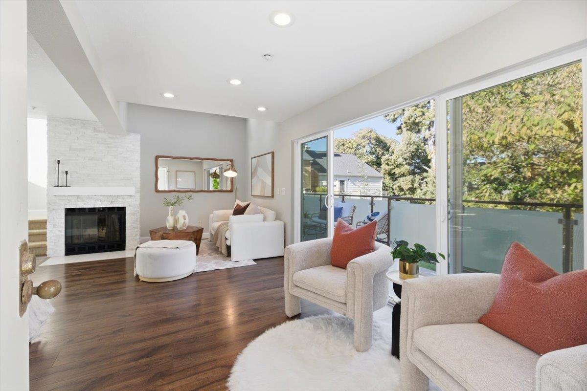363 North Rengstorff Avenue, Unit 5 Mountain View, CA 94043 - Photo 19 of 35 a living room with furniture fireplace and a large window