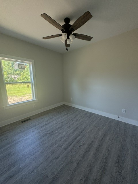 422 Shady Hill Road Dickson, TN 37055 - Photo 11 of 15 an empty room with wooden floor fan and windows