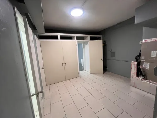 a view of walk in closet with empty racks