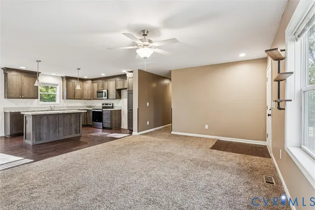 a large kitchen with a refrigerator and a stove top oven