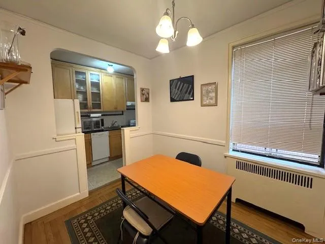 a room with chandelier fan and windows