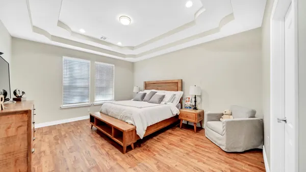 a spacious bedroom with a bed and window