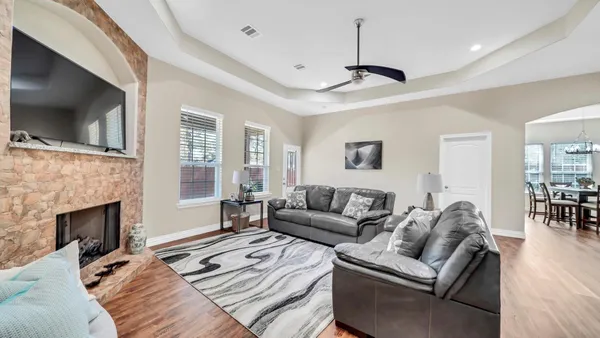 a living room with furniture a flat screen tv and a fireplace