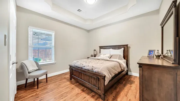 a bed room with a bed and a chair