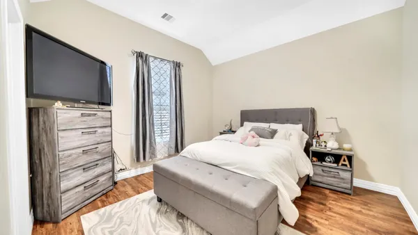 a bedroom with a bed and a flat screen tv