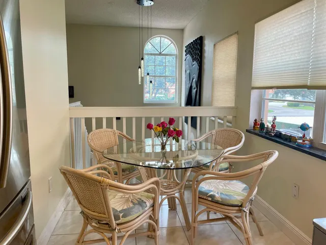 a view of a dining room with furniture and a chandelier