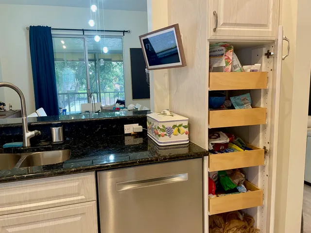 a kitchen view of a sink and a stove next to a window