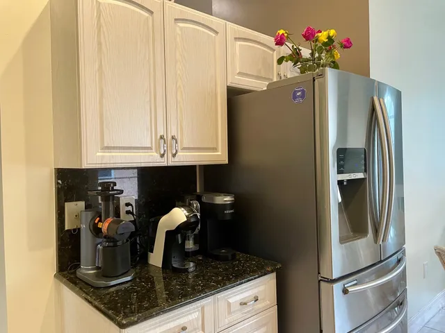a kitchen with a refrigerator and cabinets