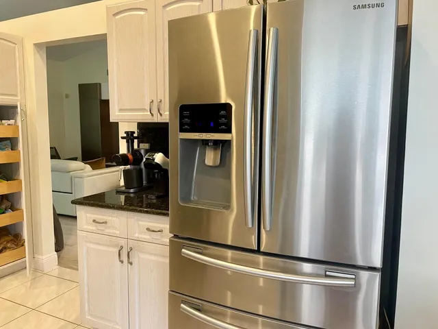 a kitchen with a refrigerator and cabinets