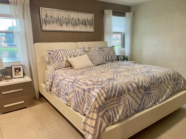 a bed sitting in a bedroom next to a window