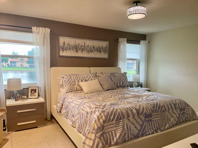 a bed sitting in a bedroom next to a window