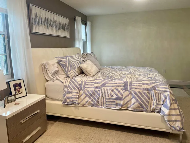 a bedroom with a bed and window