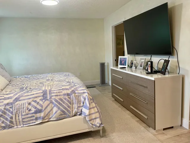 a bedroom with a bed and a flat screen tv