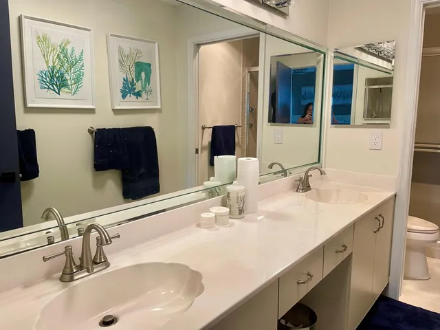 a bathroom with a double vanity sink and a mirror