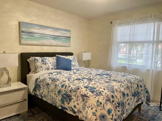 a bedroom with a bed and window