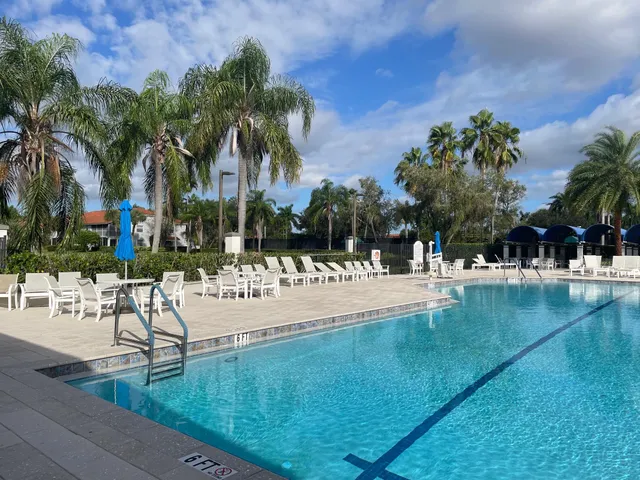 a view of a patio with table and chairs under an umbrella