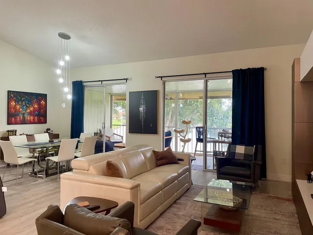 a living room with furniture and a floor to ceiling window