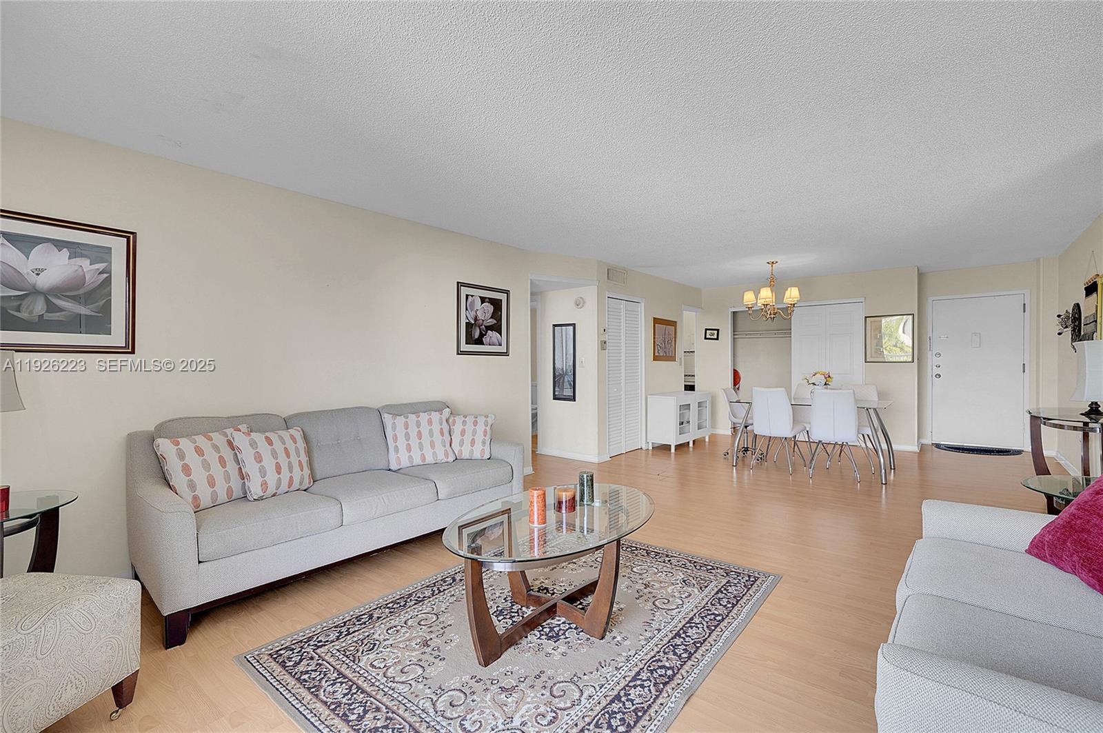 17800 Atlantic Boulevard, Unit 409 Sunny Isles Beach, FL 33160 - Photo 11 of 20 a living room with furniture or couch and a rug