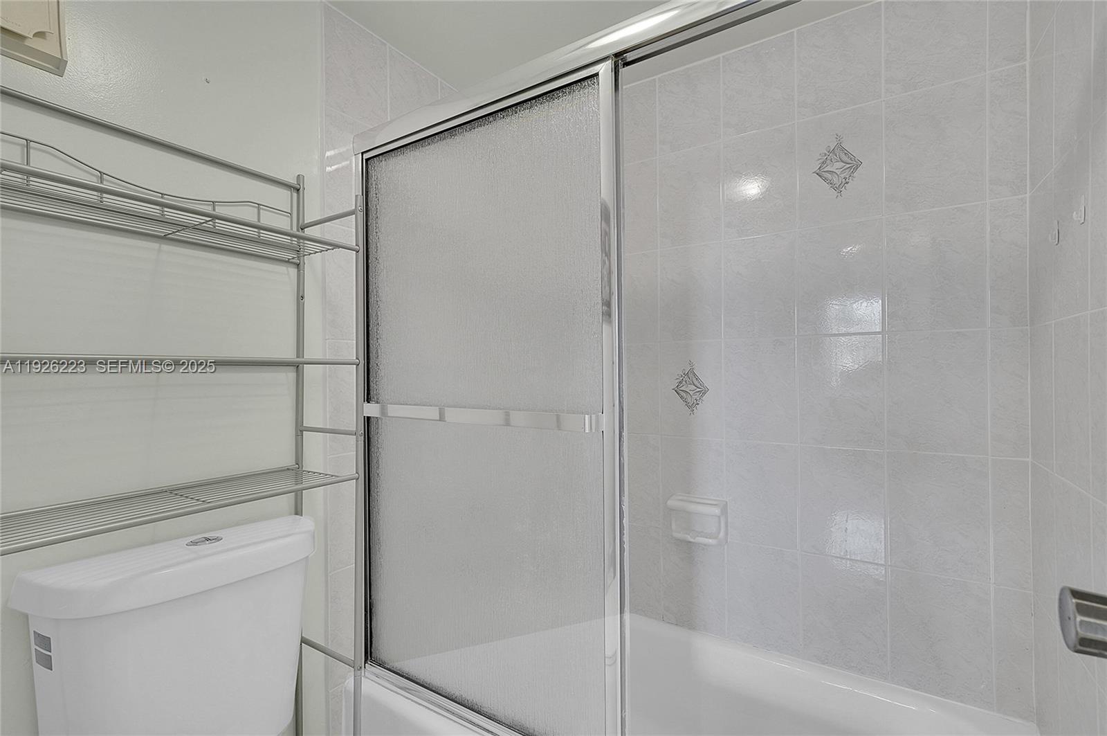 17800 Atlantic Boulevard, Unit 409 Sunny Isles Beach, FL 33160 - Photo 16 of 20 a bathroom with a shower and a glass door
