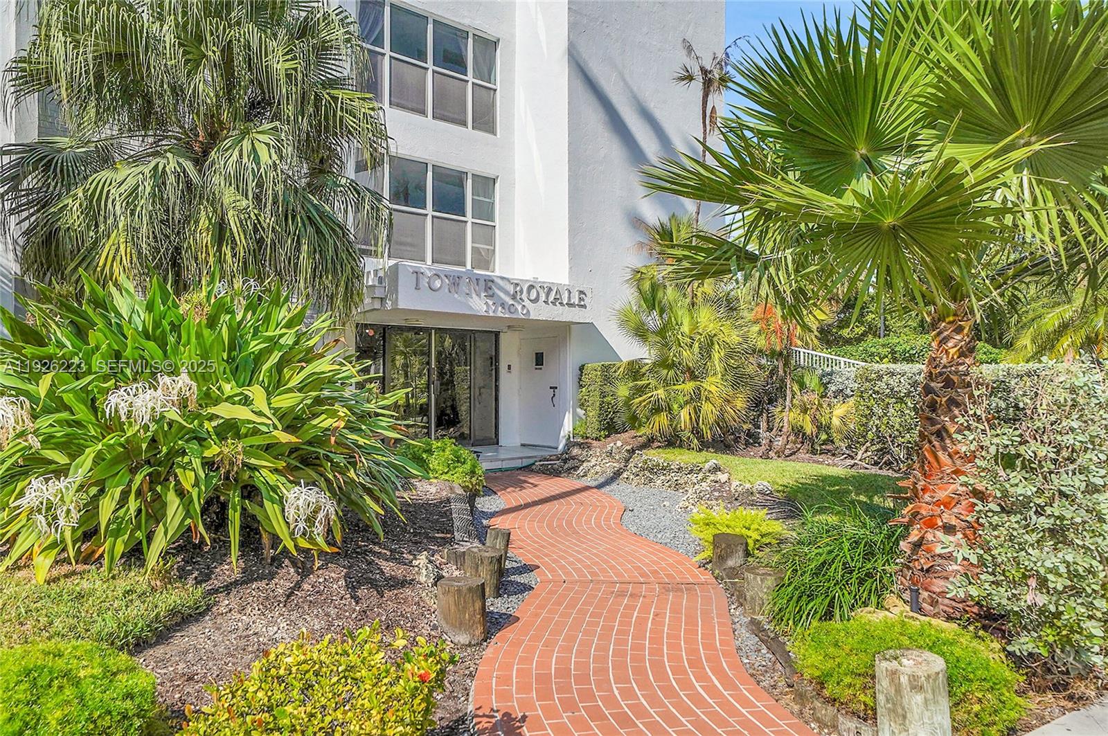 17800 Atlantic Boulevard, Unit 409 Sunny Isles Beach, FL 33160 - Photo 2 of 20 a view of a yard with plants and large trees