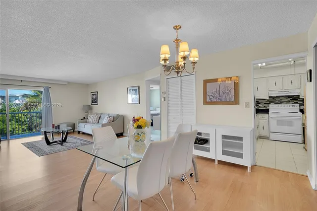 a living room with fireplace furniture and a chandelier
