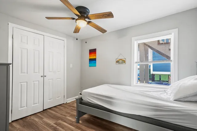 a bedroom with a large bed and a chandelier