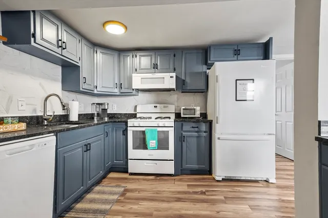 a kitchen with stainless steel appliances granite countertop a refrigerator sink and cabinets