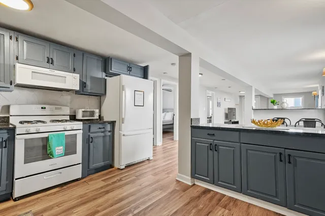 a kitchen with stainless steel appliances a stove a sink and a refrigerator