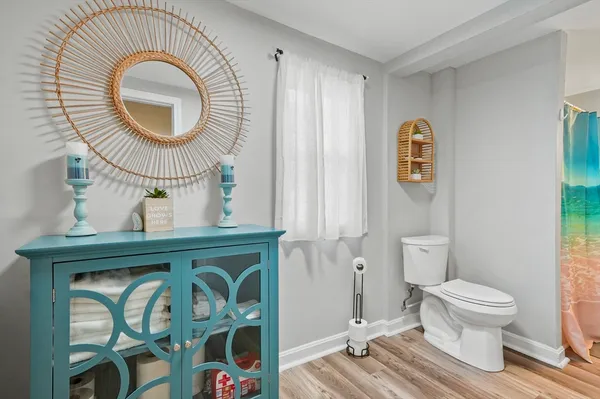 a bathroom with a toilet a sink and a mirror
