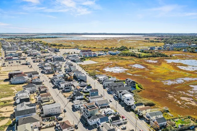 an aerial view of residential building and ocean