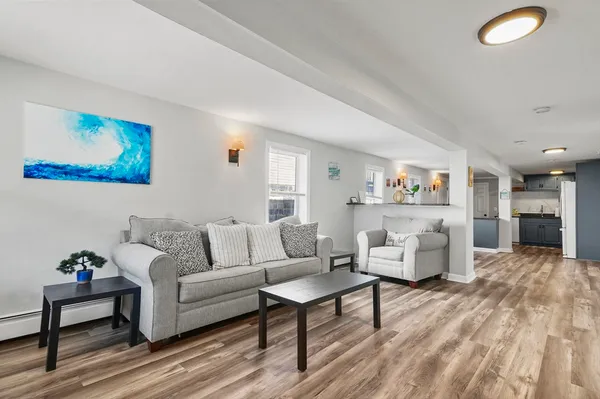 a living room with furniture and a wooden floor