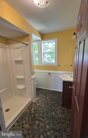 a kitchen with stainless steel appliances granite countertop a sink a stove a refrigerator a microwave oven with wooden floor and cabinets