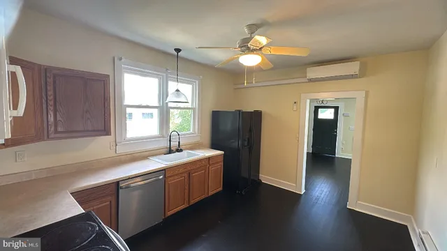 a kitchen with a refrigerator and a sink