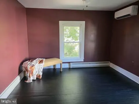 a room with wooden floor and a window