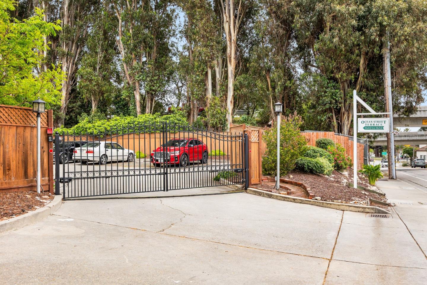 1644 Ocean Street Santa Cruz, CA 95060 - Photo 46 of 60 a street view with a fence and trees