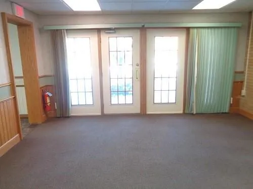 an empty room with windows and closet