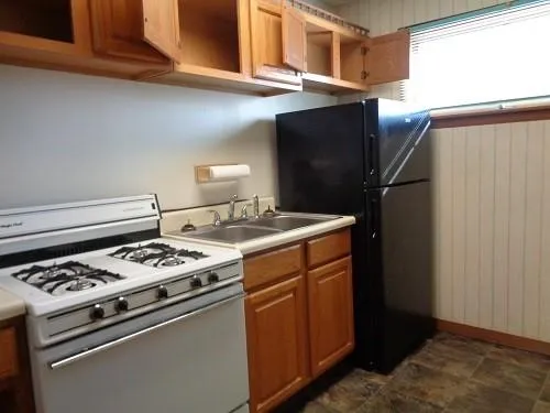 a kitchen with stainless steel appliances granite countertop a stove and a refrigerator