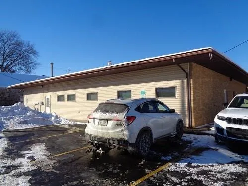 a front view of a house with parking space