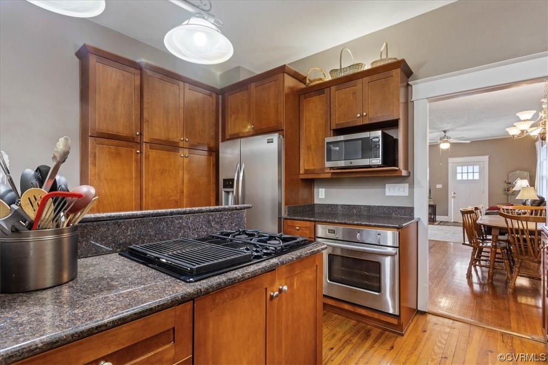 708 Hamilton Avenue Colonial Heights, VA 23834 - Photo 11 of 32 a kitchen with stainless steel appliances granite countertop a stove top oven a sink dishwasher a dining table and chairs with wooden floor